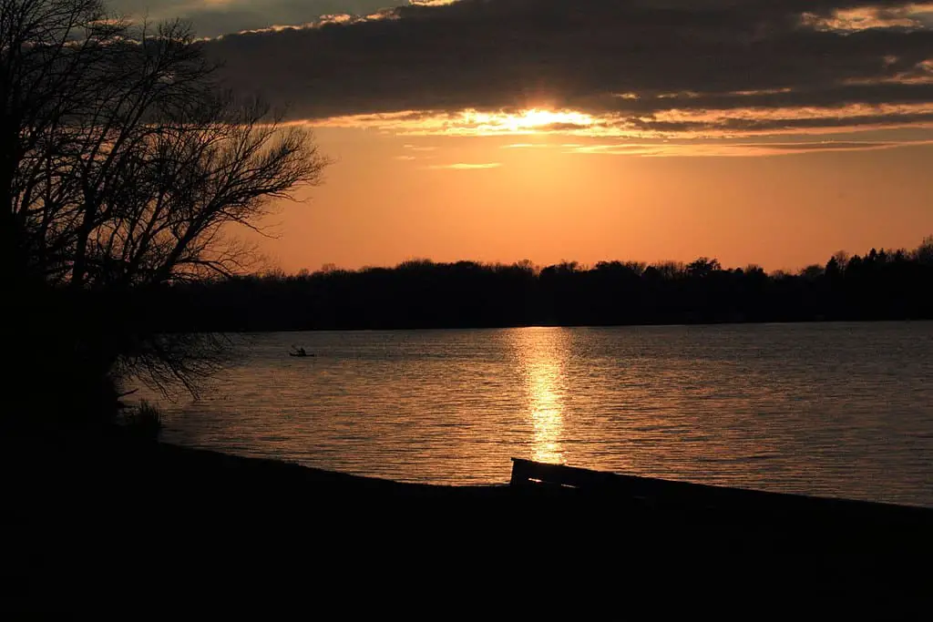 Canoe makes its way across Pike Lake at Sunset