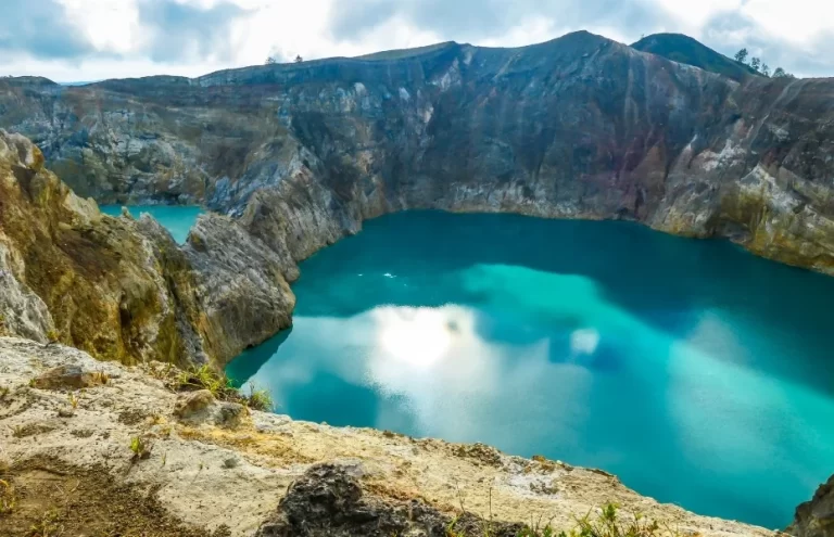 View on the turquoise and blue Kelimutu volcanic crater lakes in Flores, Indonesia