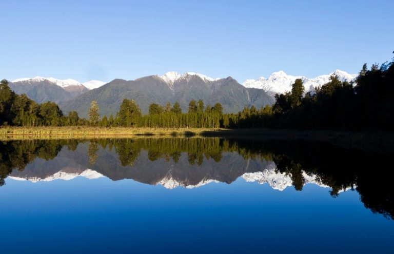 Mountains reflected in stunning Lake Matheson on the South Island of New Zealand