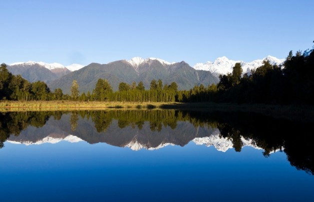 Mountains reflected in stunning Lake Matheson on the South Island of New Zealand