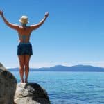Woman enjoying view of Lake Tahoe from atop a rock