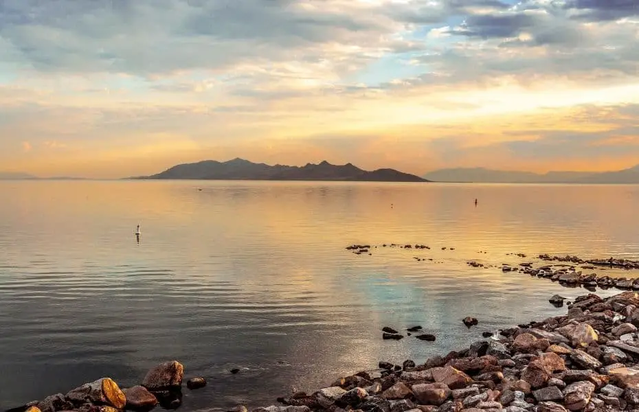 Sunrise lights the sky orange above the Great Salt Lake in Utah