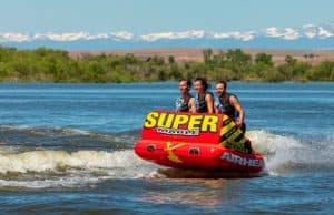 Three tubers ride chariot style on the Super Mable towable tube from airhead